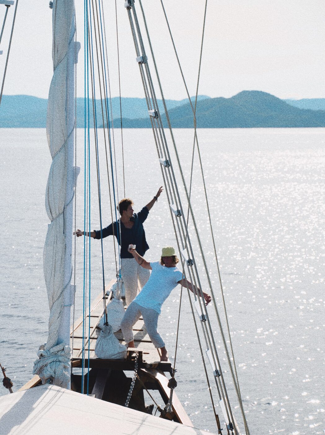 Jaro celebrating on a sailboat at sunset