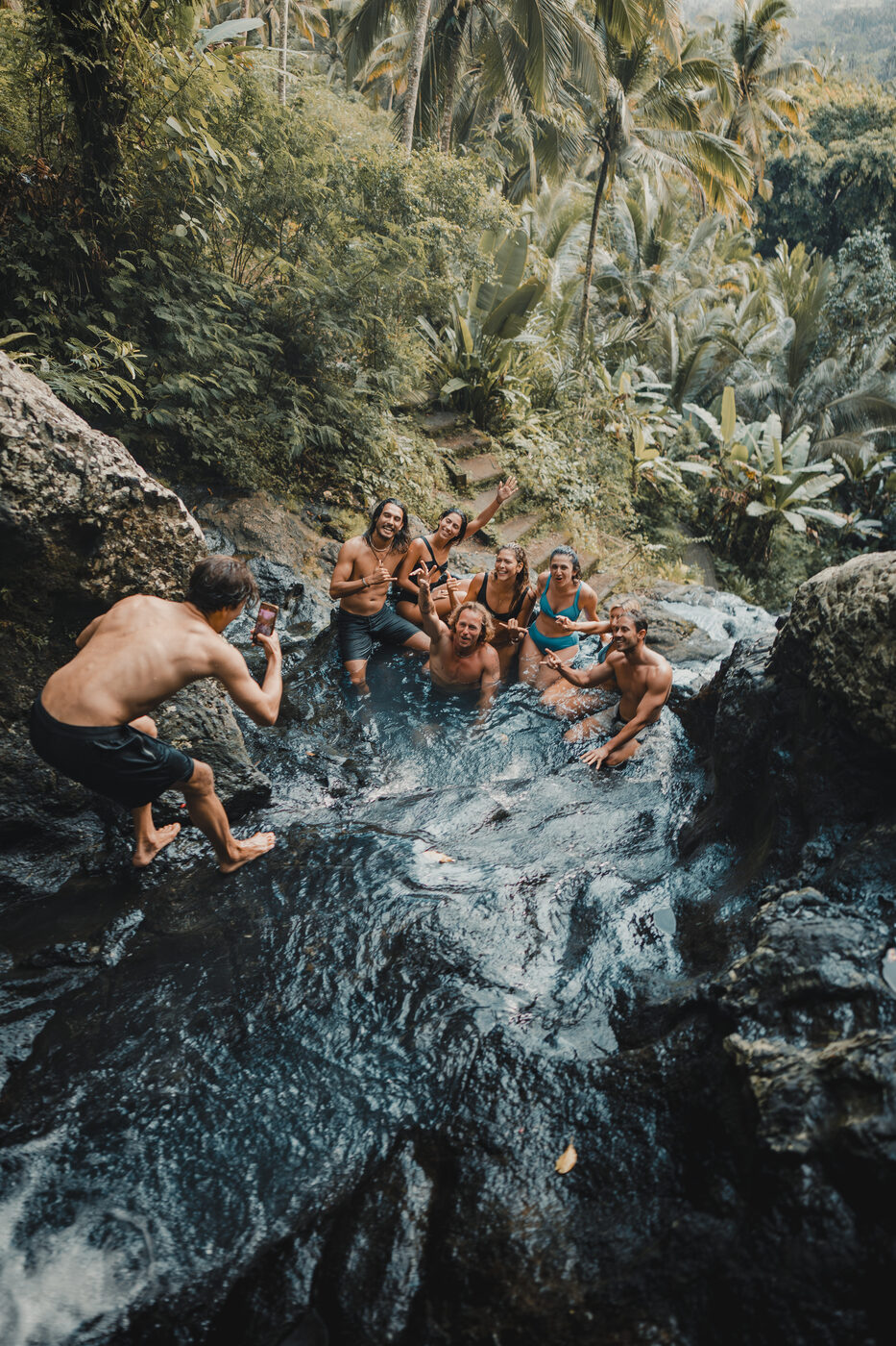Jaro filming friends in a jungle pool